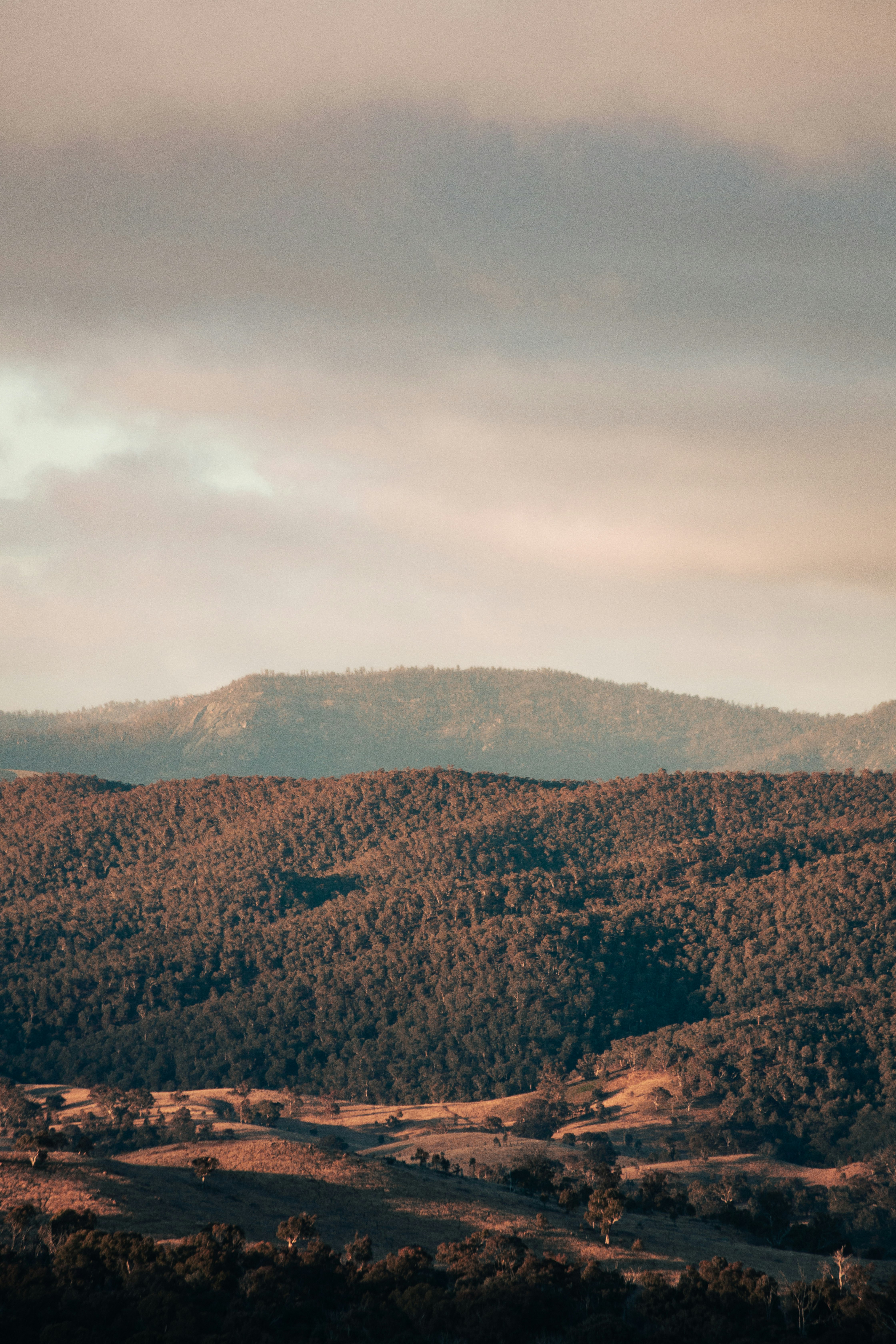 brown mountains under white clouds during daytime